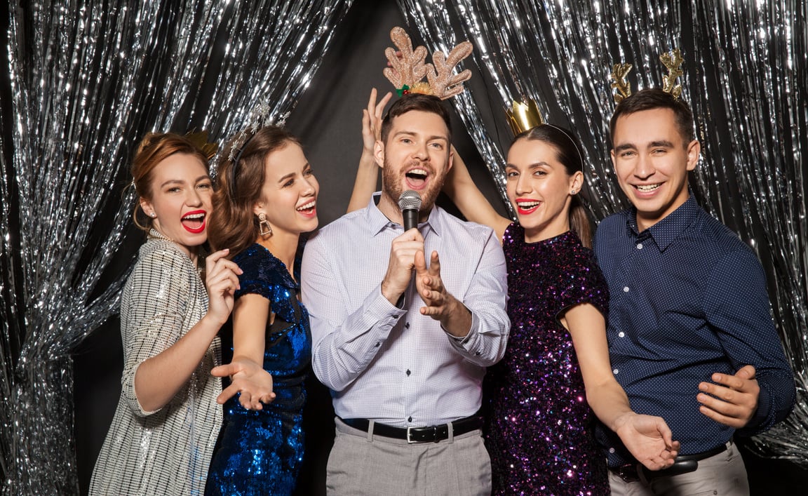 Friends with Microphone Singing at Christmas Party