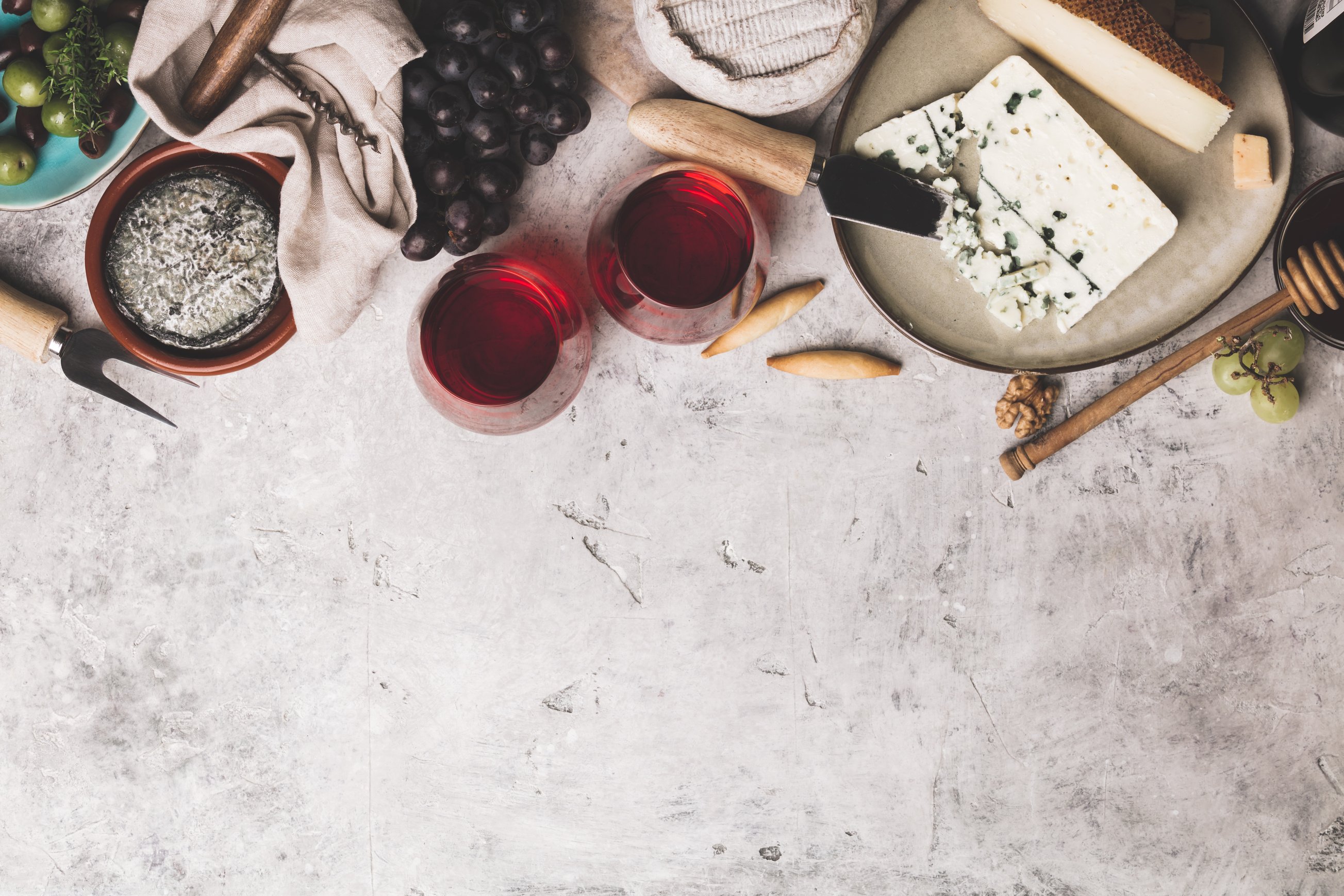 Red Wine with Charcuterie Assortment on Rustic Concrete Backgrou